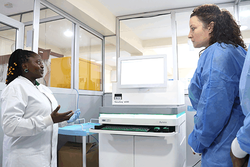 Dr Mewamba Estelle, postdoctoral researcher at CRID, showcasing Novaseq6000 to Dr Paige