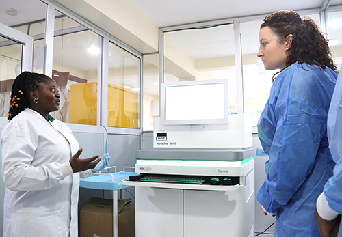 Dr Mewamba Estelle, postdoctoral researcher at CRID, showcasing Novaseq6000 to Dr Paige